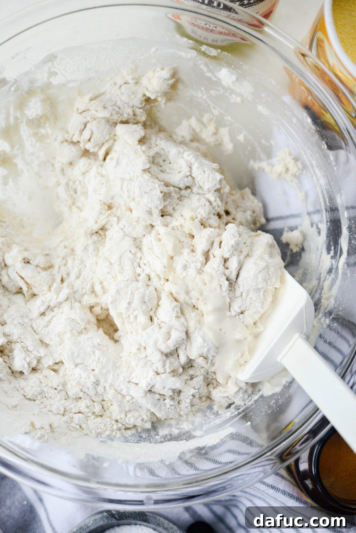 No-Knead Ciabatta: Easy Homemade Perfection 8 Mixing ciabatta dough with a rubber spatula until all flour is incorporated
