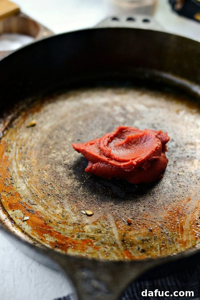 add tomato paste to skillet.