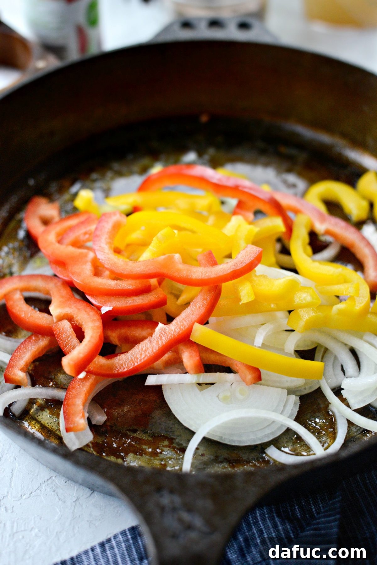 remove browned andouille and add onions and peppers to skillet.