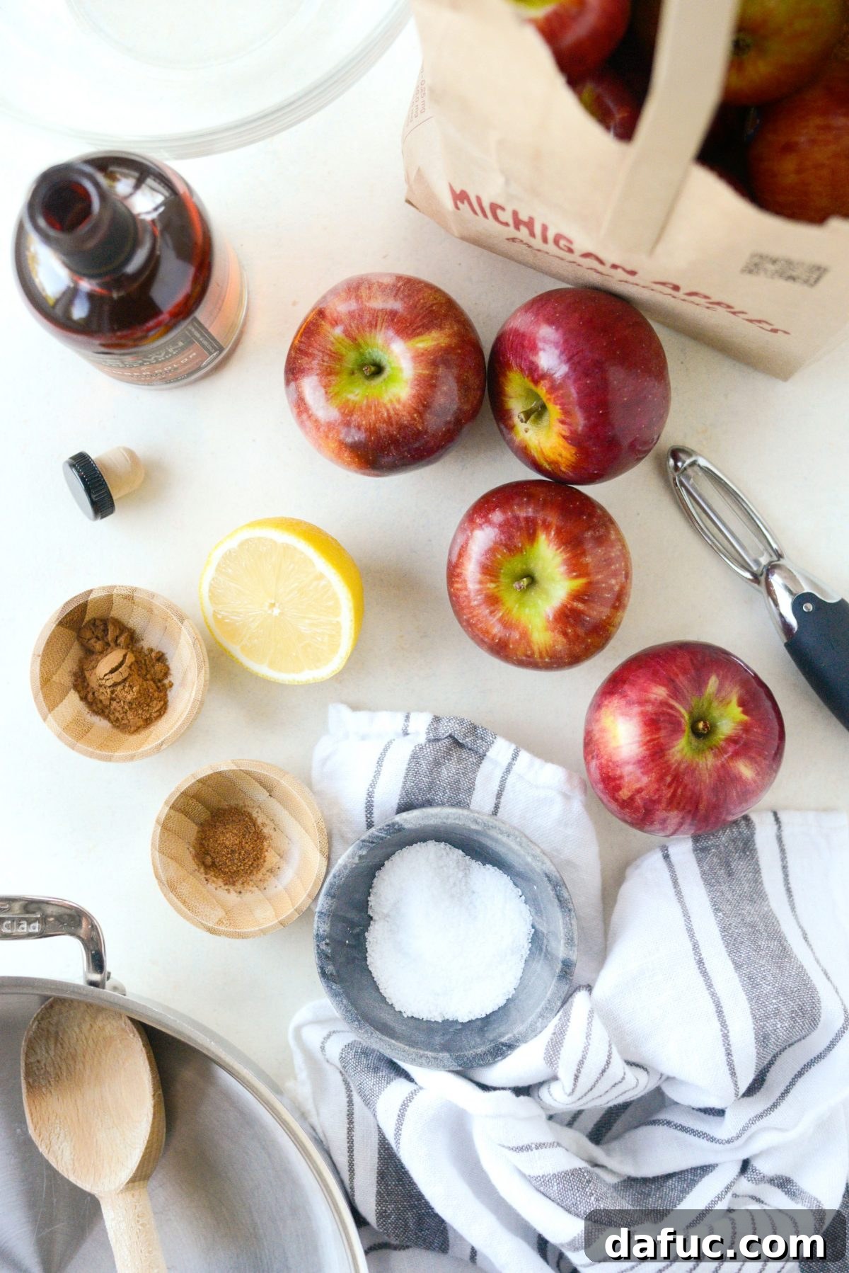 Simple ingredients for Naturally Sweetened Skillet Applesauce: apples, lemon, water, spices, maple syrup, and salt.