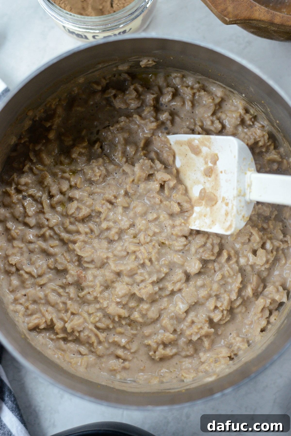 The creamy Apple Chai Oatmeal resting in the saucepan after cooking, perfectly thick and ready to serve.