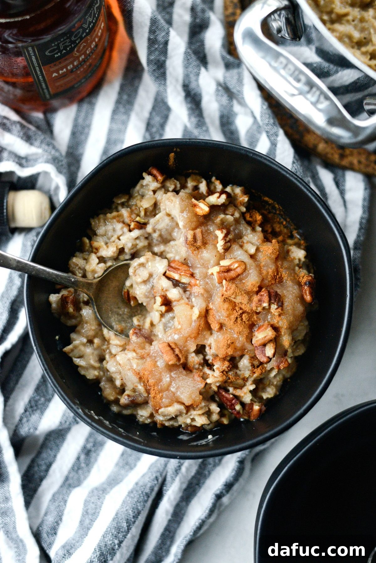 A close-up of Apple Chai Oatmeal on a spoon, highlighting its creamy texture and the spice visible within.
