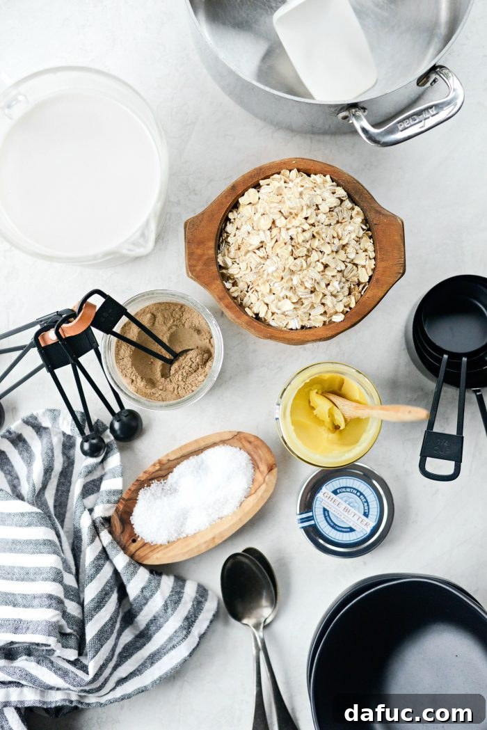 A collection of fresh ingredients laid out on a wooden surface, including oats, chai spice, apples, maple syrup, and milk, ready for Apple Chai Oatmeal preparation.