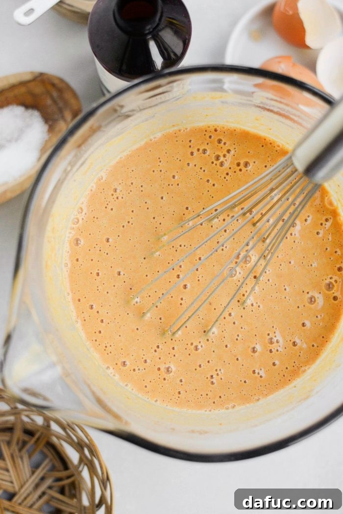 Sheet Pan Pumpkin Pie 12 Whisking the pumpkin pie filling to perfection, ensuring all ingredients are well incorporated