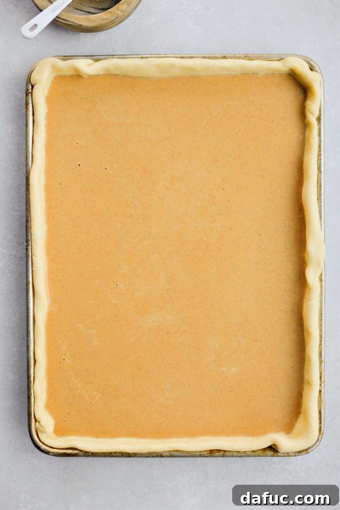 Sheet Pan Pumpkin Pie 14 A perfectly baked Pumpkin Slab Pie, golden brown crust and set filling