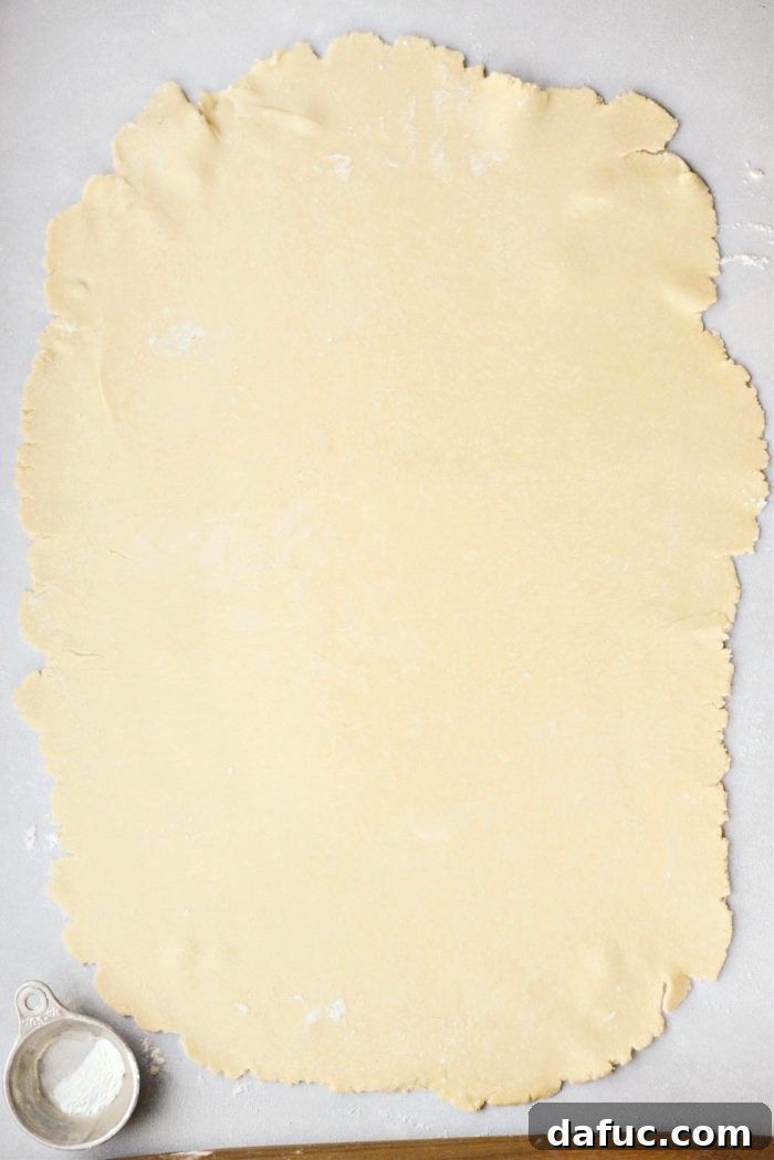 Sheet Pan Pumpkin Pie 7 Carefully rolling out the pie dough into a large rectangle