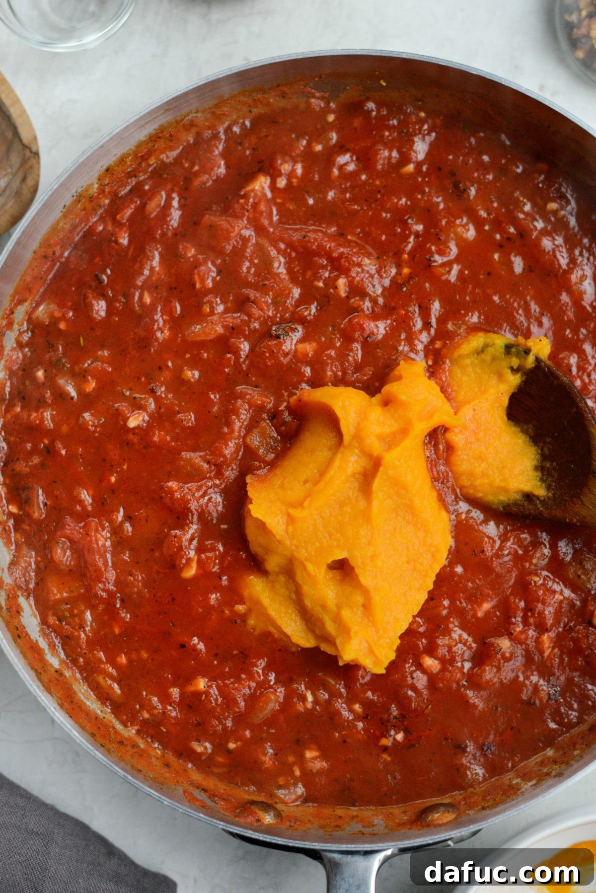 Sweet Butternut Marinara 14 Butternut squash purée being added to the marinara sauce
