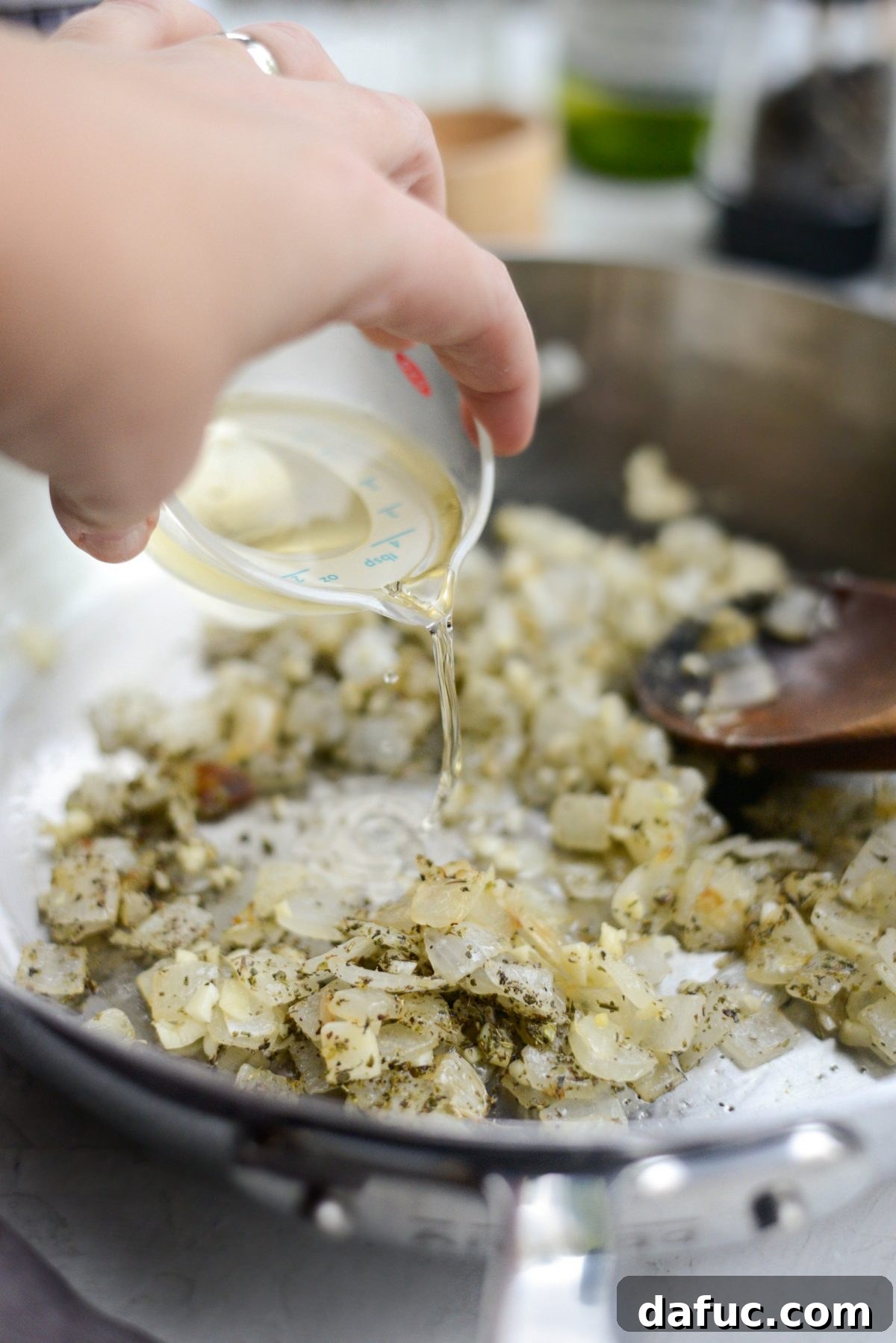 Sweet Butternut Marinara 10 Dry white wine being poured into the skillet to deglaze