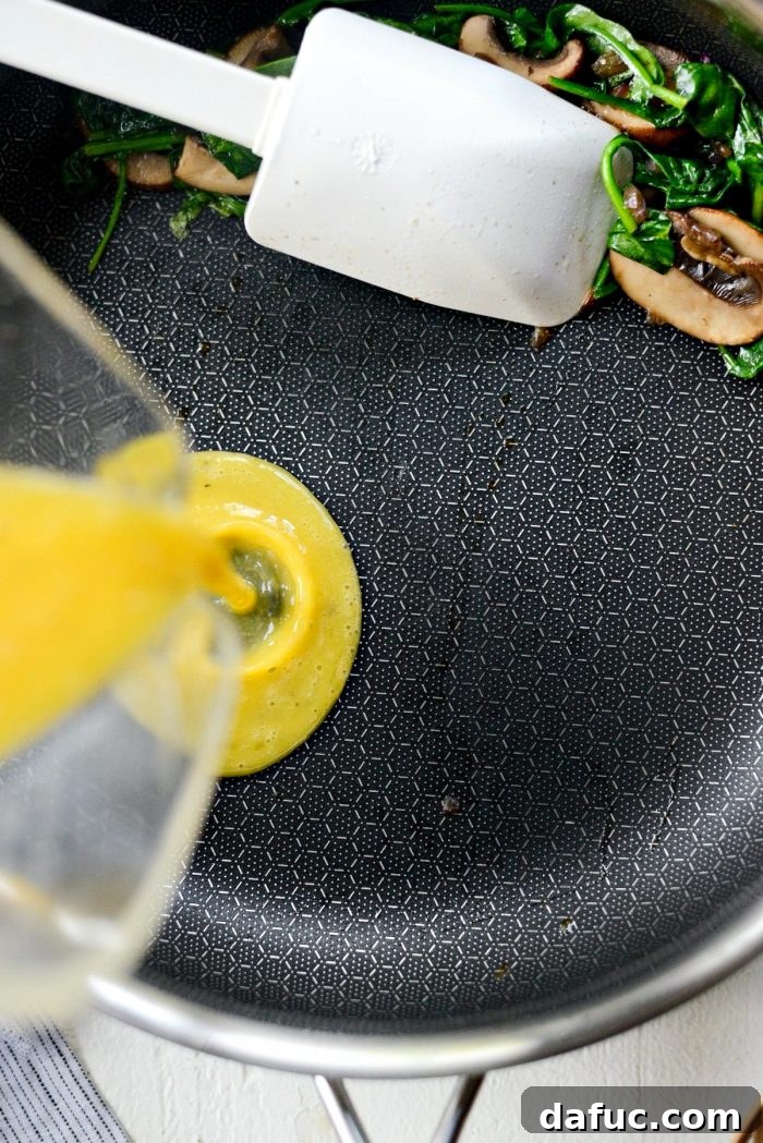 Vibrant Spinach and Mushroom Scramble 12 Scoot vegetables to one side and pour whisked eggs into the empty pan space