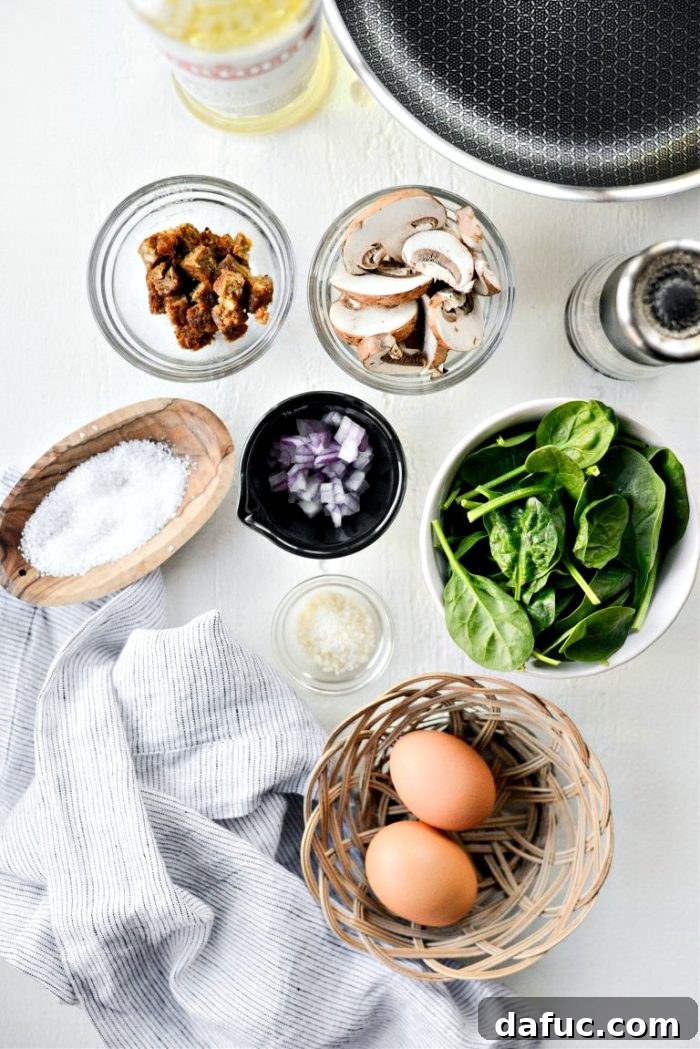 Vibrant Spinach and Mushroom Scramble 4 Ingredients for Healthy Spinach and Mushroom Scramble laid out on a board