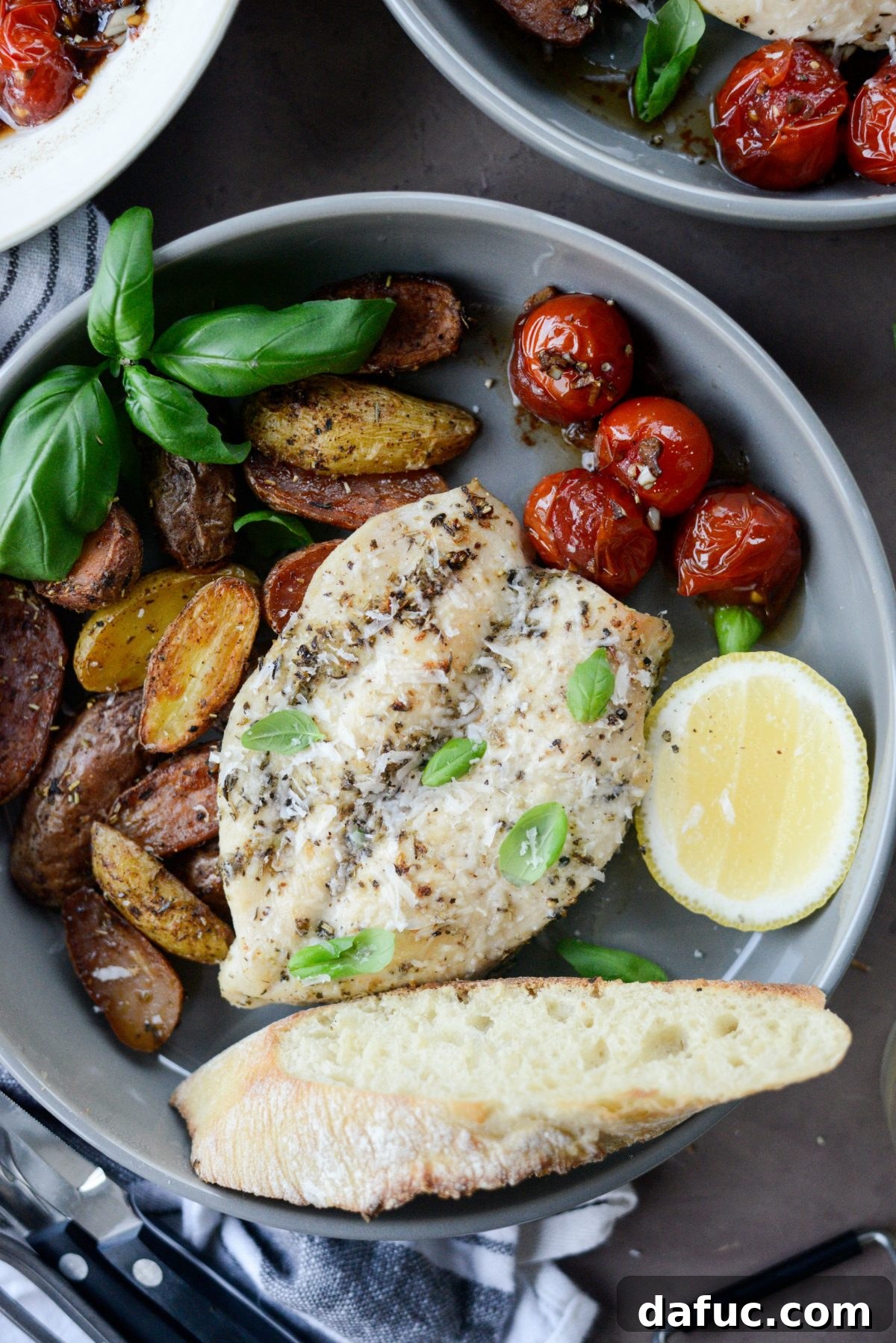 Tuscan Chicken and Potato Sheet Pan Dinner with Balsamic Burst Tomatoes - A delightful one-pan meal featuring seasoned chicken and roasted potatoes.