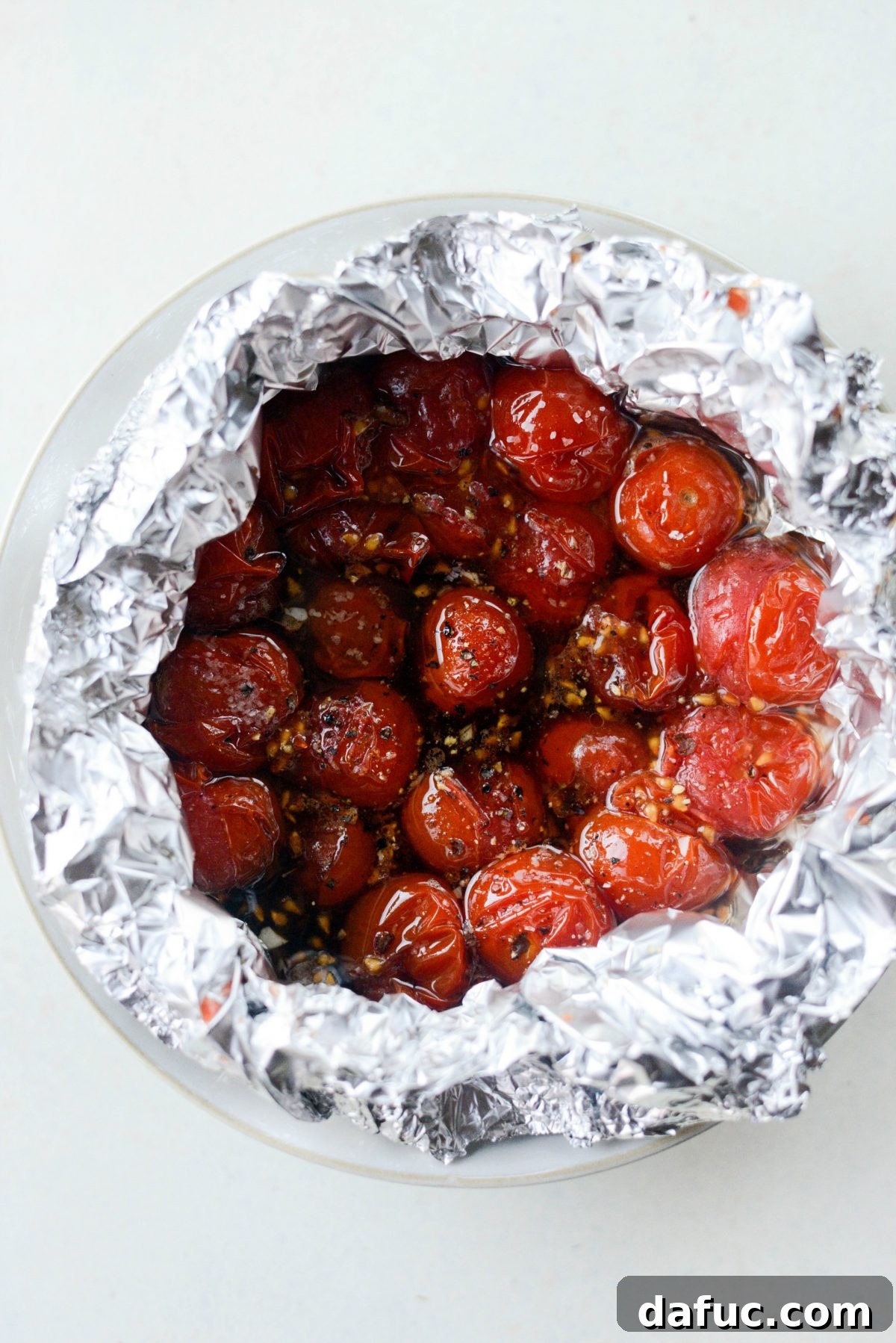 Roasted balsamic burst tomatoes in foil, ready to be served