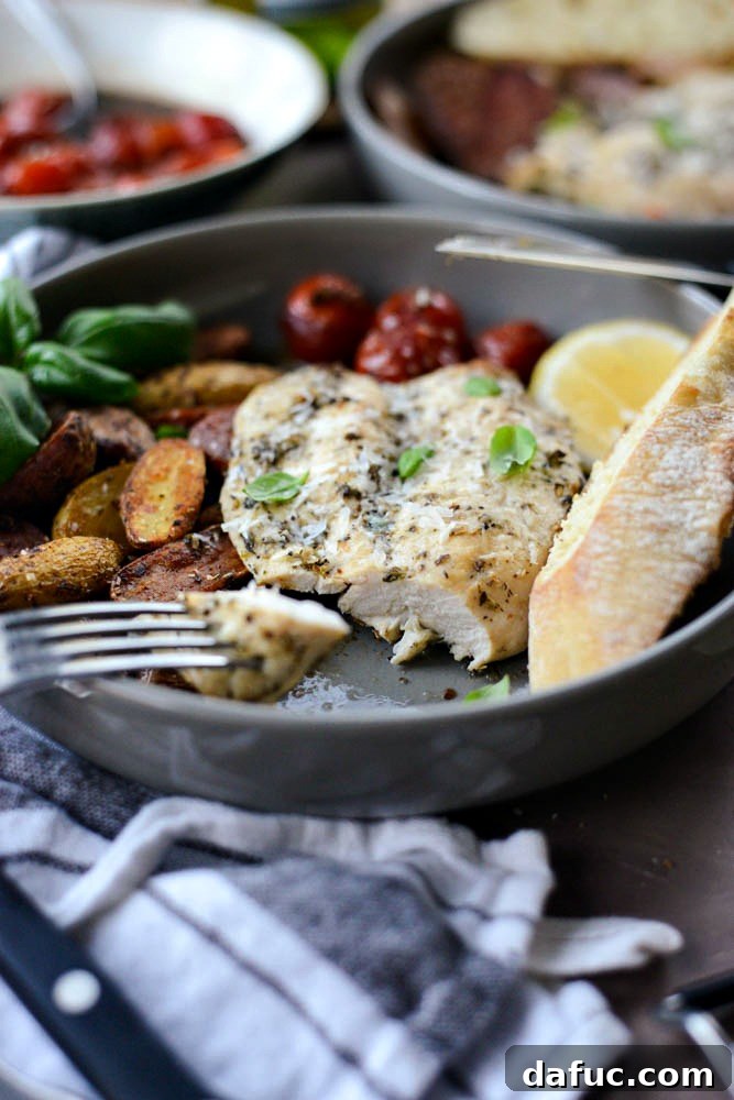 Forkful of Tuscan Chicken and Potato Sheet Pan Dinner with Balsamic Burst Tomatoes