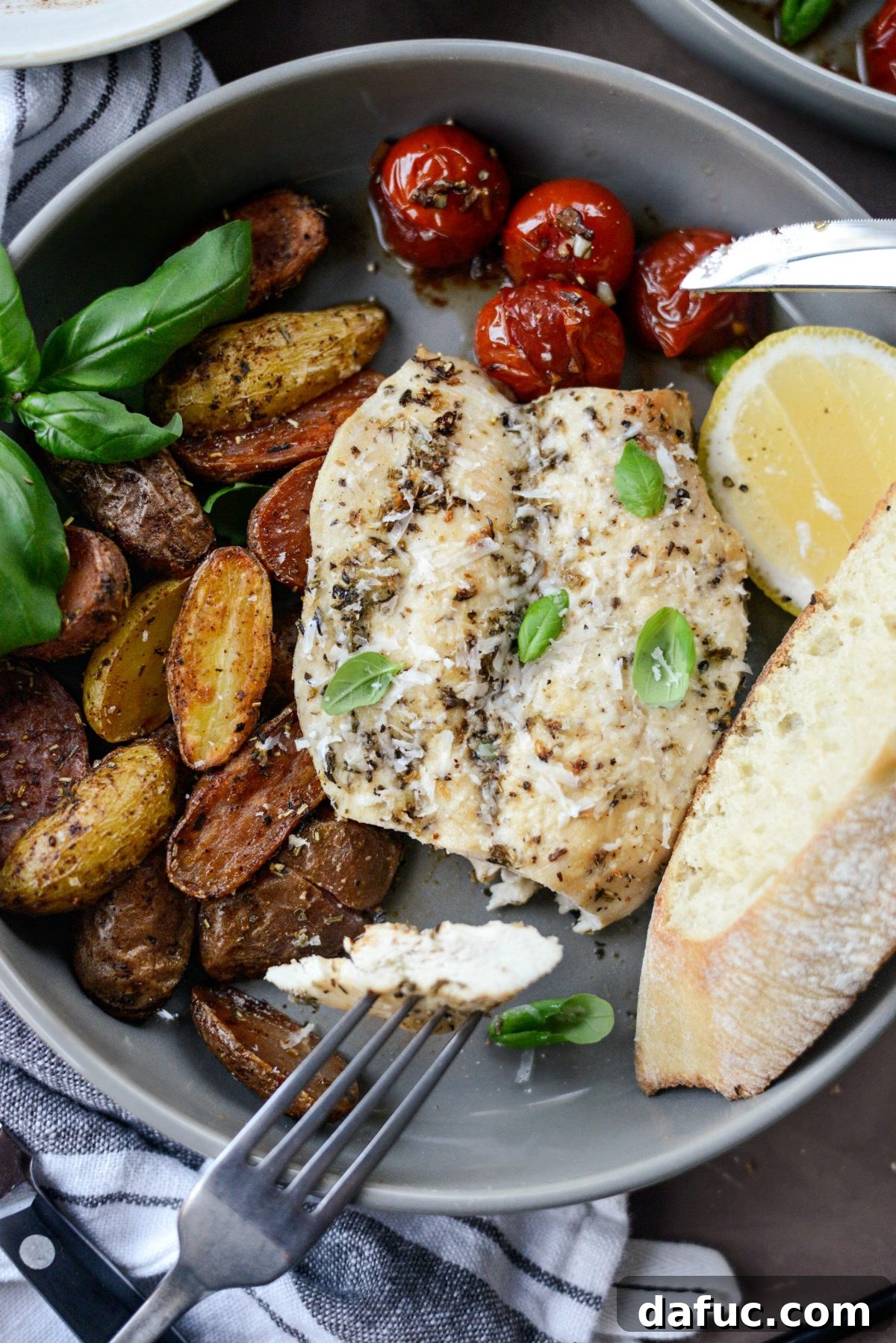 Close-up of Tuscan Chicken and Potato Sheet Pan Dinner with Balsamic Burst Tomatoes, showing texture
