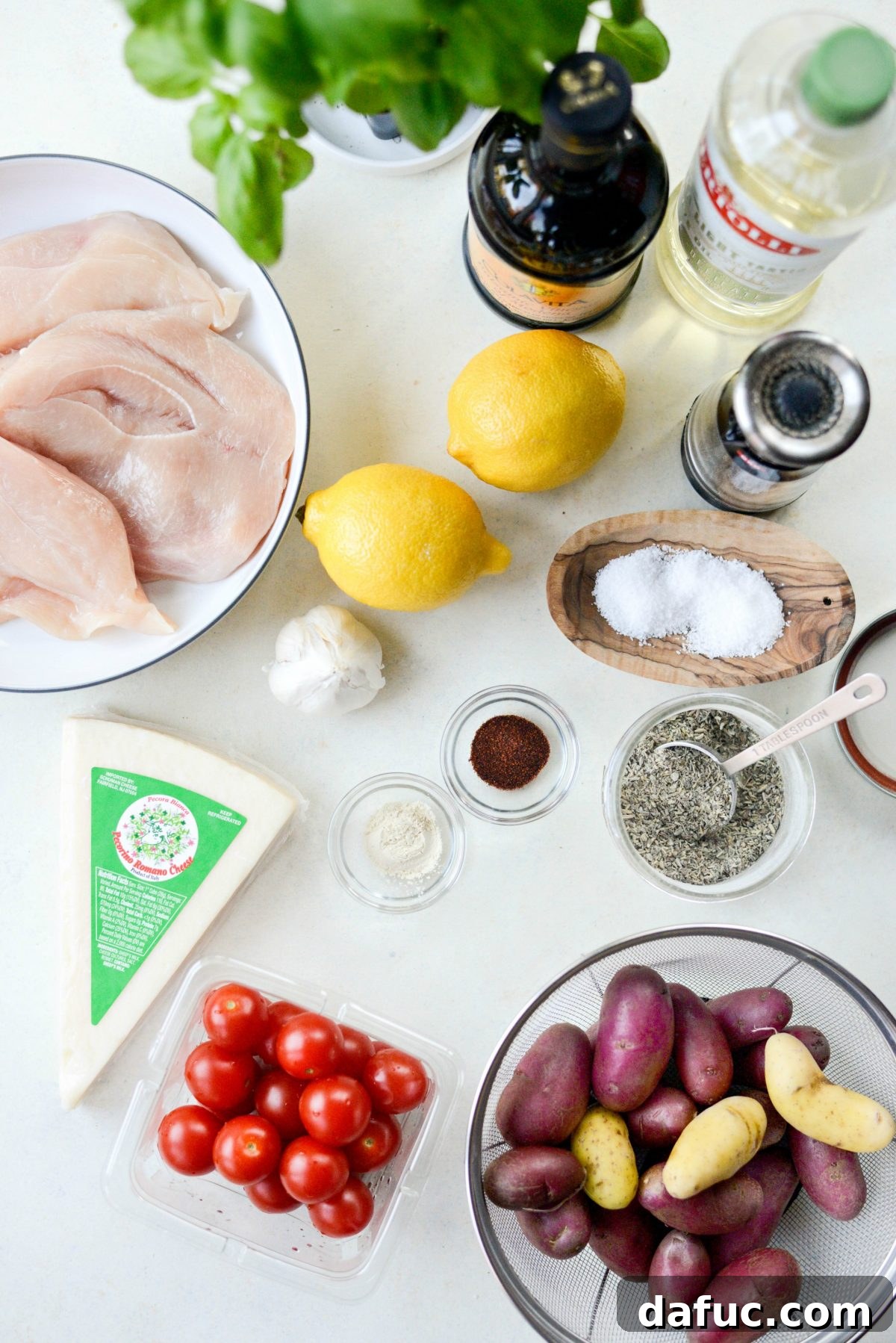 Ingredients laid out for Tuscan Chicken and Potato Sheet Pan Dinner with Balsamic Burst Tomatoes