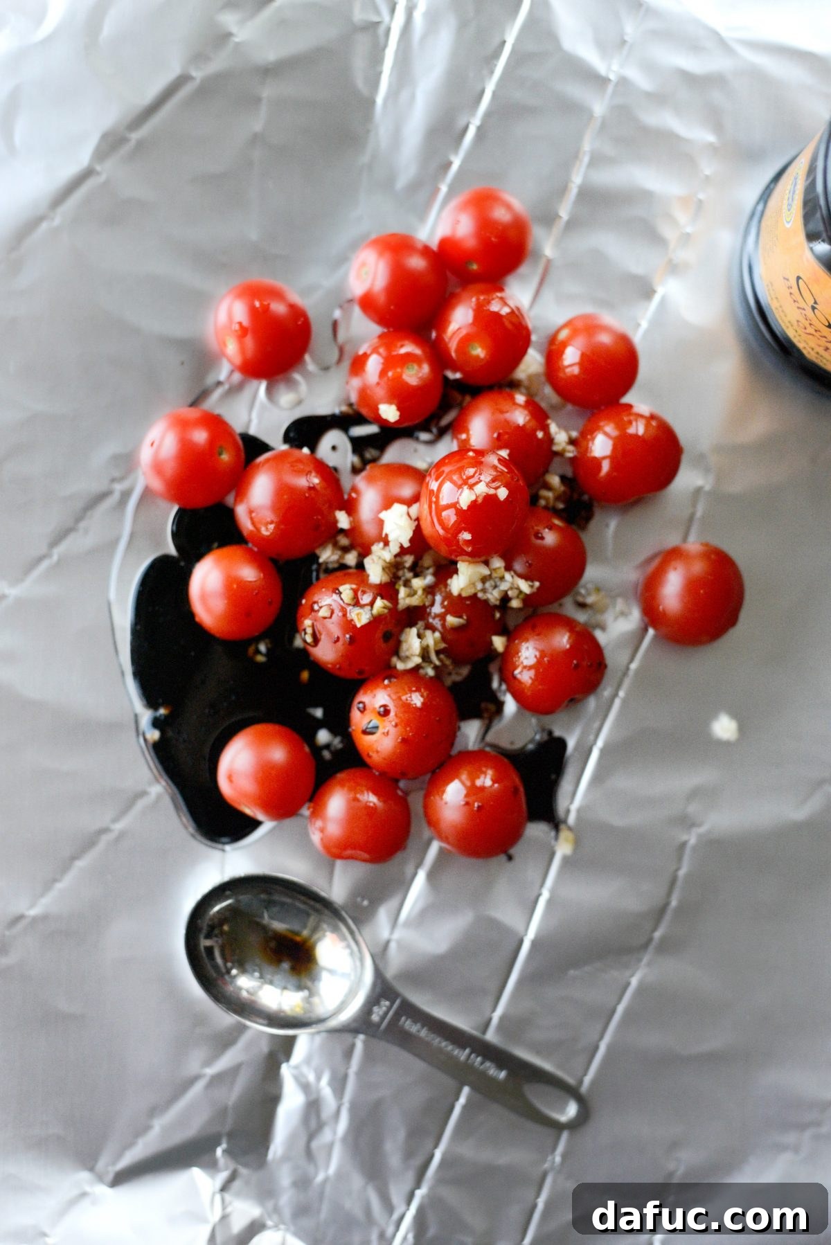 Seasoning cherry tomatoes with kosher salt and black pepper