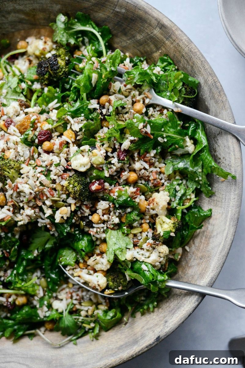 Warm Roasted Greens & Florets Salad 2 Roasted Broccoli Cauliflower Kale Salad with serving spoons.