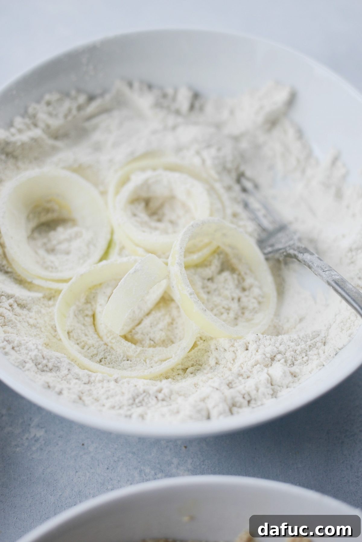 for extra crispy onion rings, dip onion slices in flour