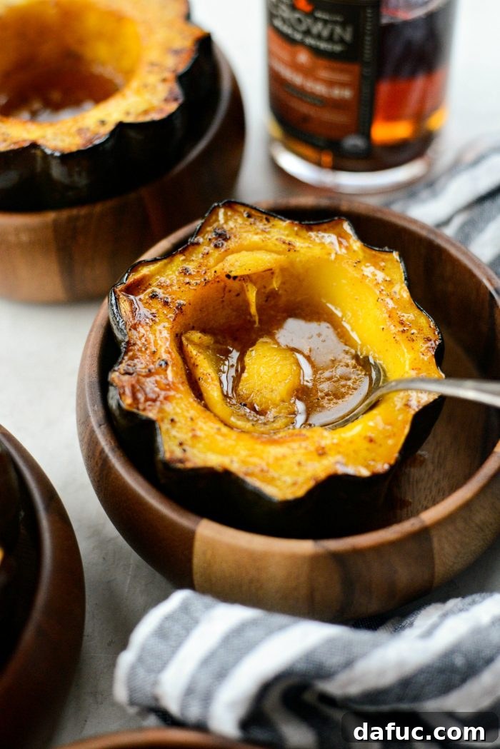 A beautifully presented maple butter roasted acorn squash, glistening with glaze, perfect as a side dish for any occasion.