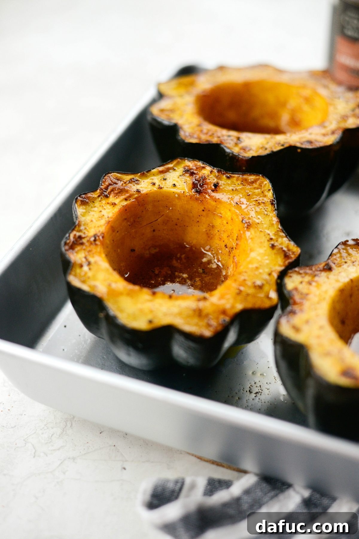 Finished maple butter roasted acorn squash, perfectly tender and caramelized, ready to be served.