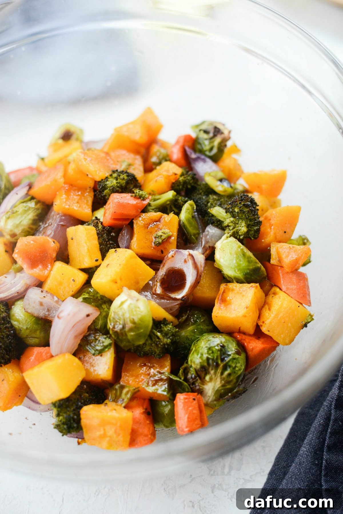 Harvest Roasted Vegetables with Honey Balsamic Glaze on Creamy Goat Cheese Polenta 15 veggies back in a bowl and drizzled with balsamic vinegar and honey