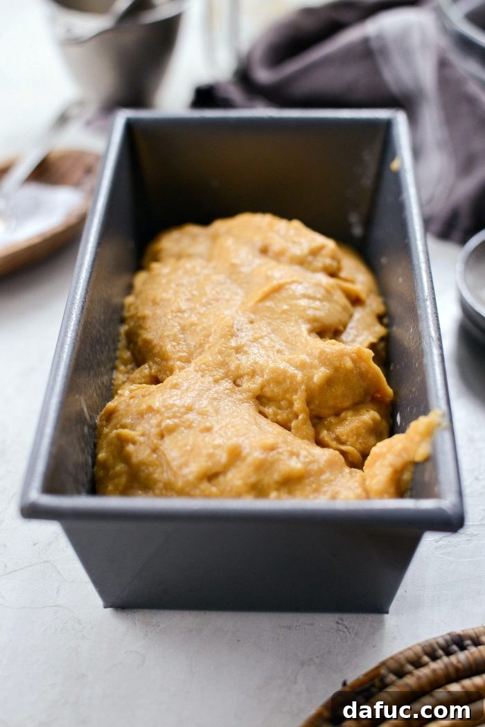 Spiced Pumpkin Ginger Loaf with Luxe Maple Brown Butter Glaze 11 Pumpkin bread batter in a prepared loaf pan, smoothed on top and ready for baking. Ensures an even bake and beautiful presentation.