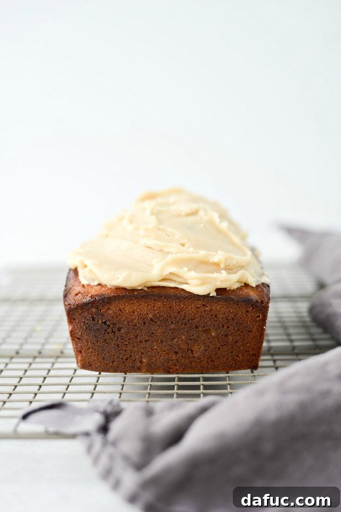 Spiced Pumpkin Ginger Loaf with Luxe Maple Brown Butter Glaze 14 Baked ginger pumpkin bread cooling on a wire rack after being removed from the loaf pan. Essential for setting before icing.