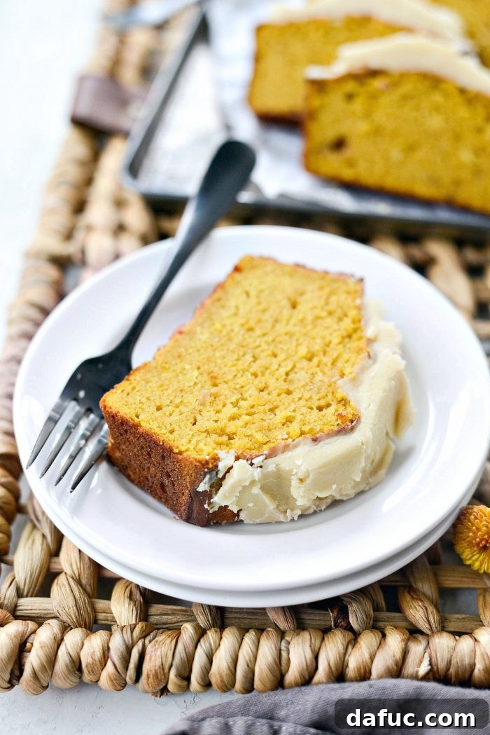 Spiced Pumpkin Ginger Loaf with Luxe Maple Brown Butter Glaze 17 Full loaf of Ginger Pumpkin Bread with ample maple brown butter icing, showcasing its delicious appearance. A perfect fall sweet bread.