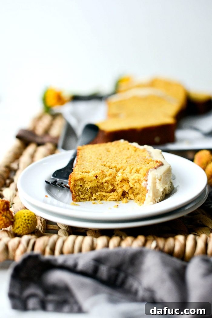 Spiced Pumpkin Ginger Loaf with Luxe Maple Brown Butter Glaze 18 A slice of ginger pumpkin bread with icing, ready to be enjoyed. The ultimate fall comfort food dessert.