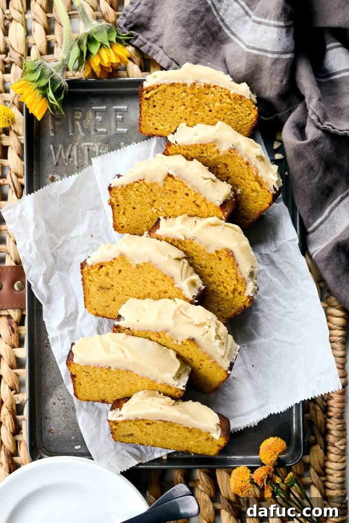 Spiced Pumpkin Ginger Loaf with Luxe Maple Brown Butter Glaze 3 Close-up of freshly baked Ginger Pumpkin Bread, showcasing its moist texture and golden-brown crust. A delightful treat for any fall occasion.