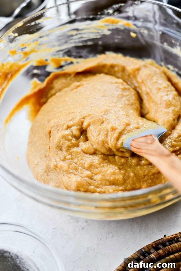 Spiced Pumpkin Ginger Loaf with Luxe Maple Brown Butter Glaze 10 Mixing pumpkin bread batter, gently stirring wet into dry ingredients until just combined. Prevents overmixing for a tender loaf.