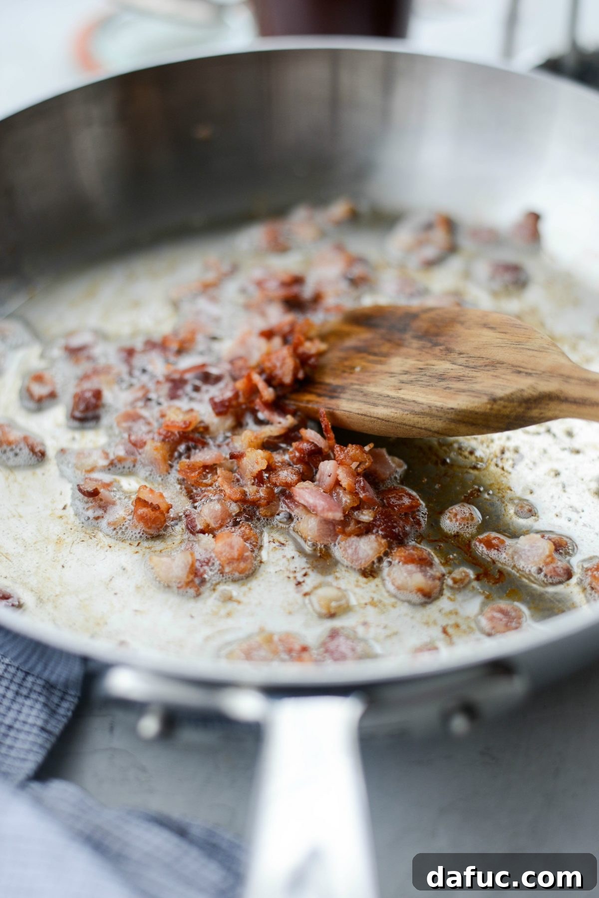 Cheesy Skillet Monterey Chicken 5 Diced bacon cooking in a skillet until crispy
