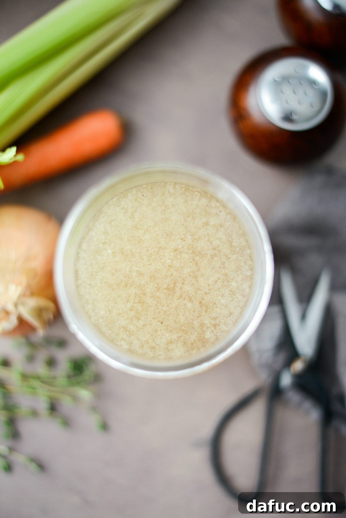 Homemade Turkey Stock in a cup with a spoon