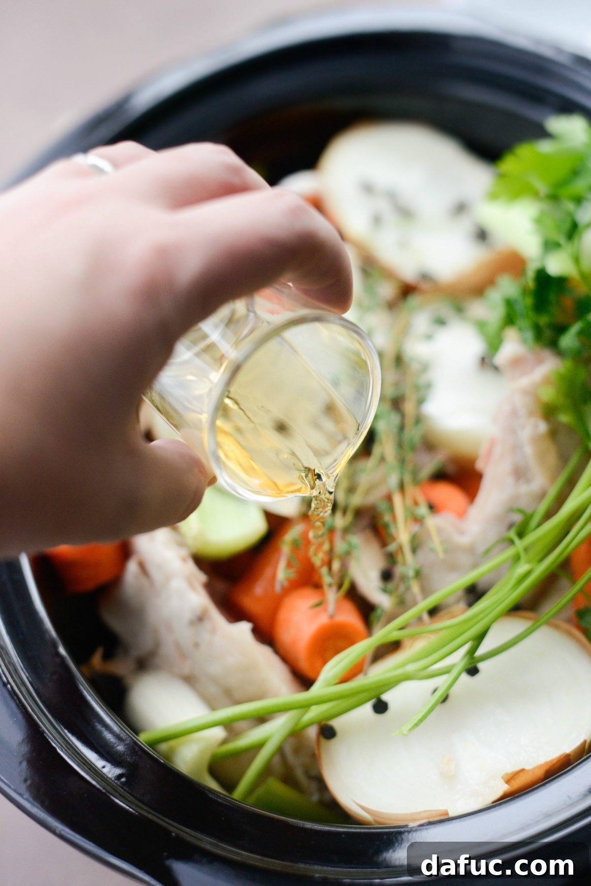 Pour in apple cider vinegar into slow cooker