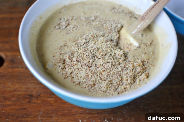 Mixing the banana and almond batter with a spatula