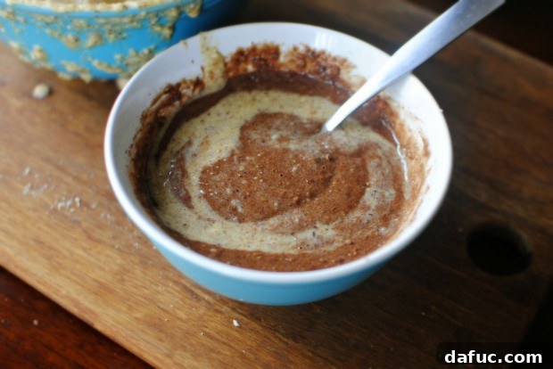 Stirring cocoa powder into a portion of the banana-almond batter