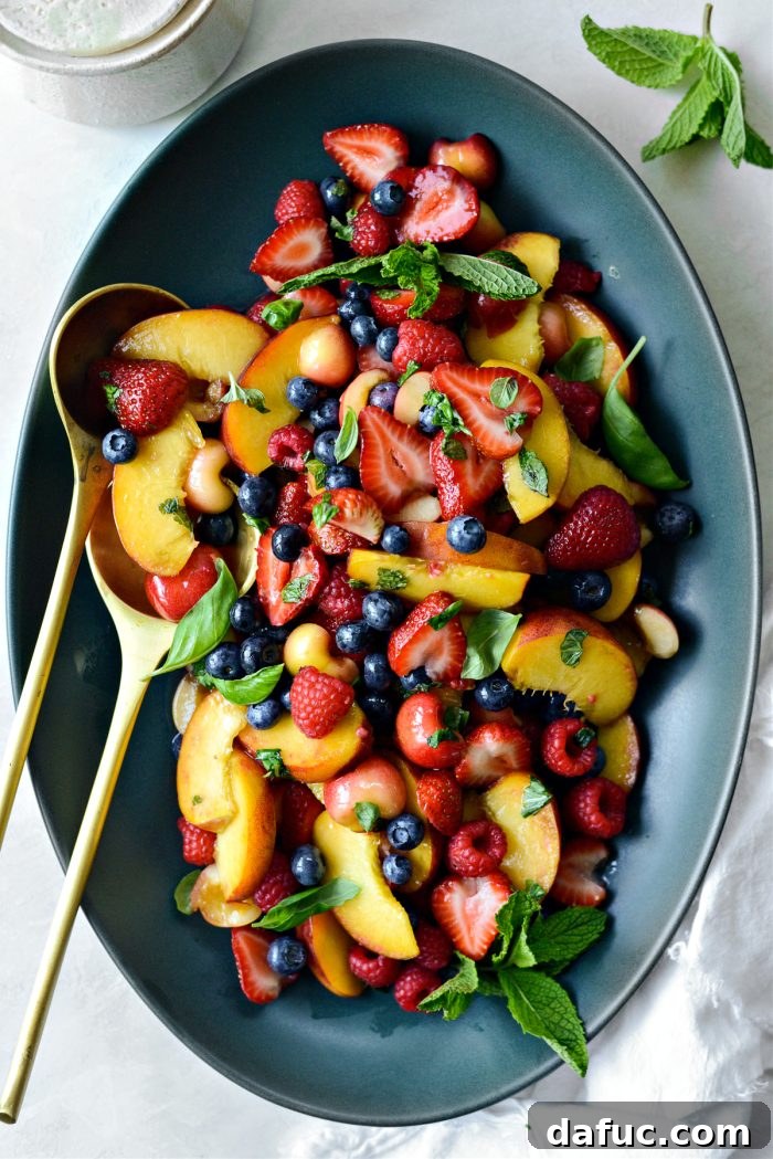 Close-up of the delightful Summer Fruit Salad, highlighting the fresh, juicy combination of peaches, berries, and cherries