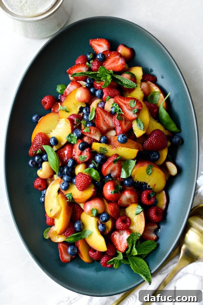 Beautifully presented Summer Fruit Salad in a serving bowl, garnished with fresh mint leaves