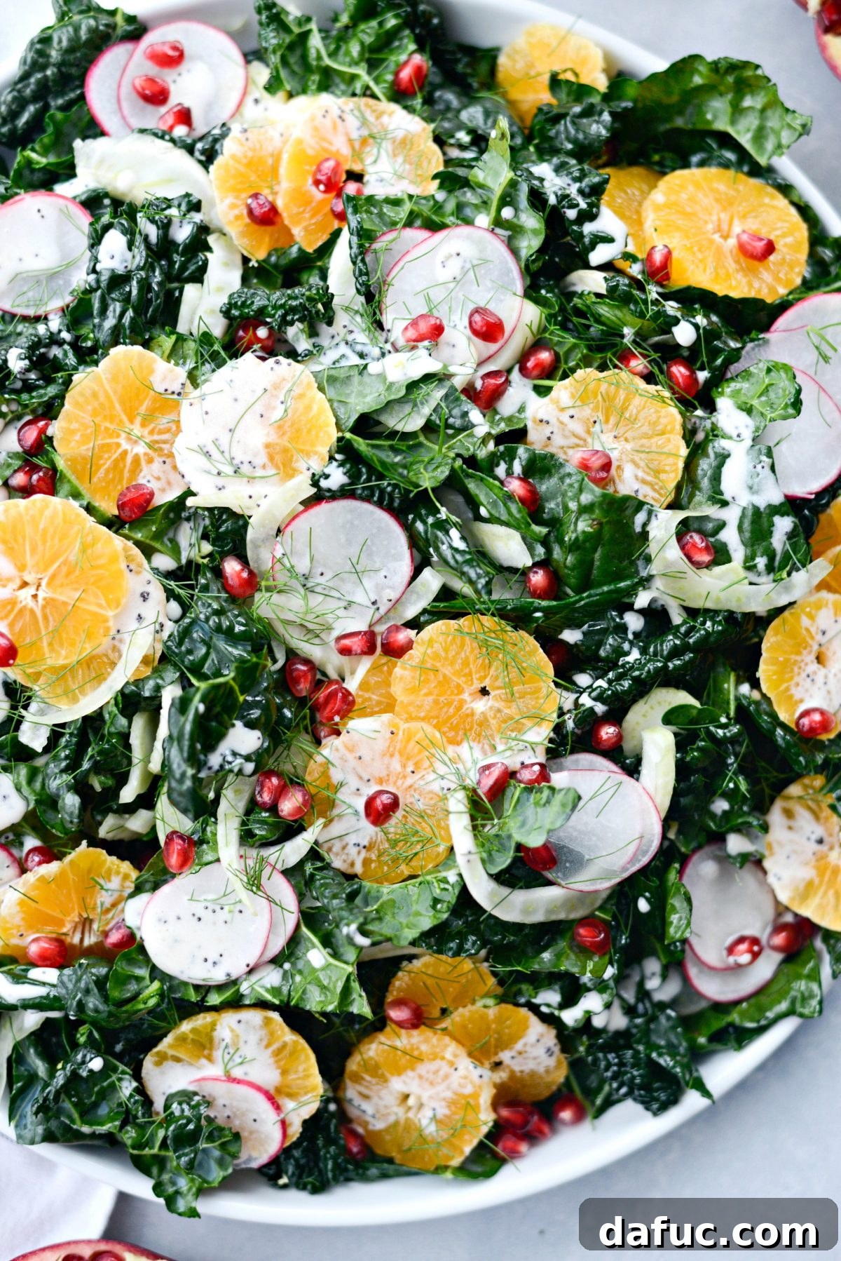 Close-up of Winter Clementine Fennel and Kale Salad with pomegranate seeds