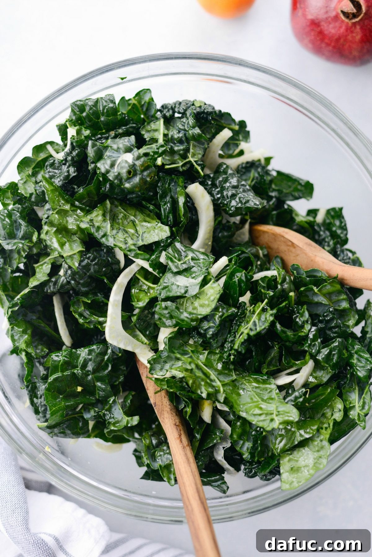 Tossing kale and fennel together in a large bowl
