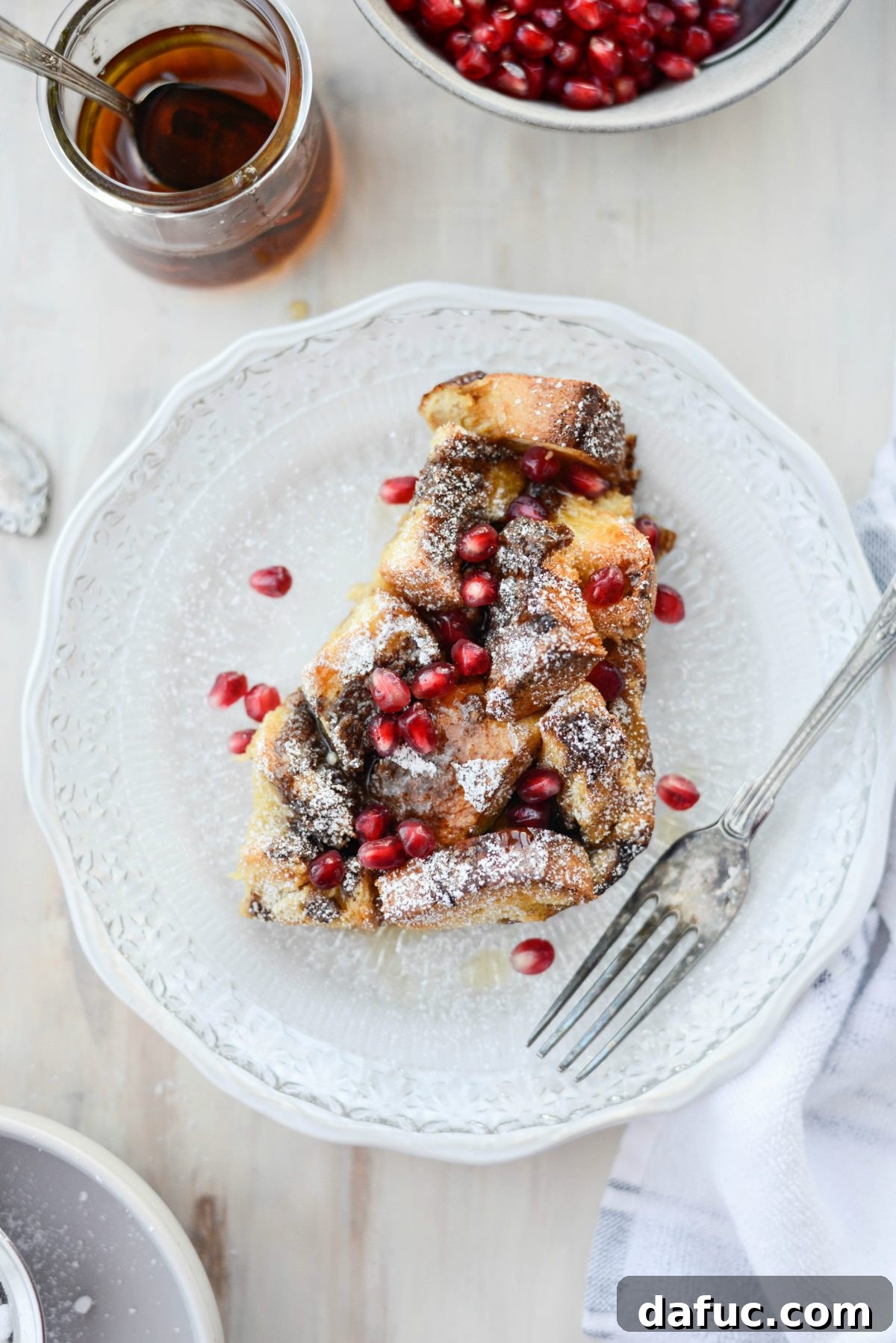 Gingerbread French Toast Bake on a glass plate, garnished with powdered sugar