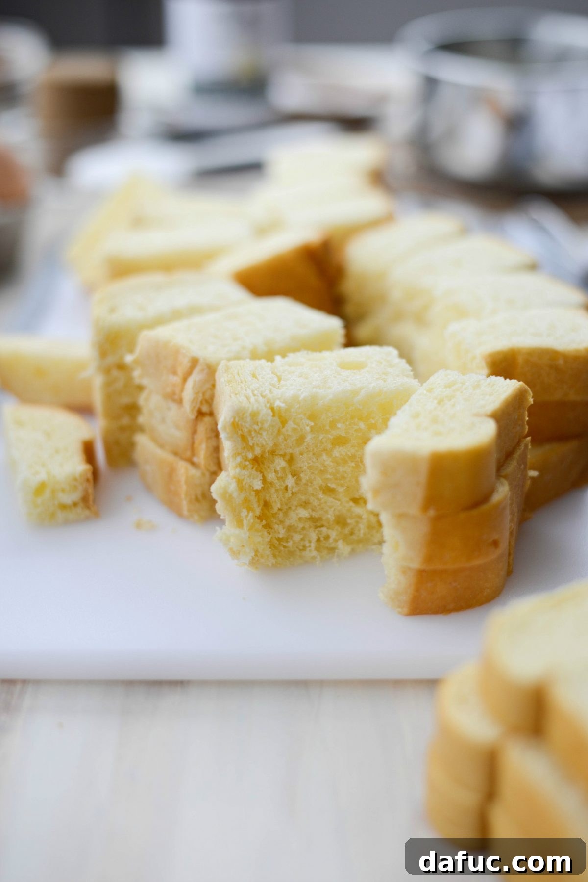 Cubed brioche bread in a baking dish