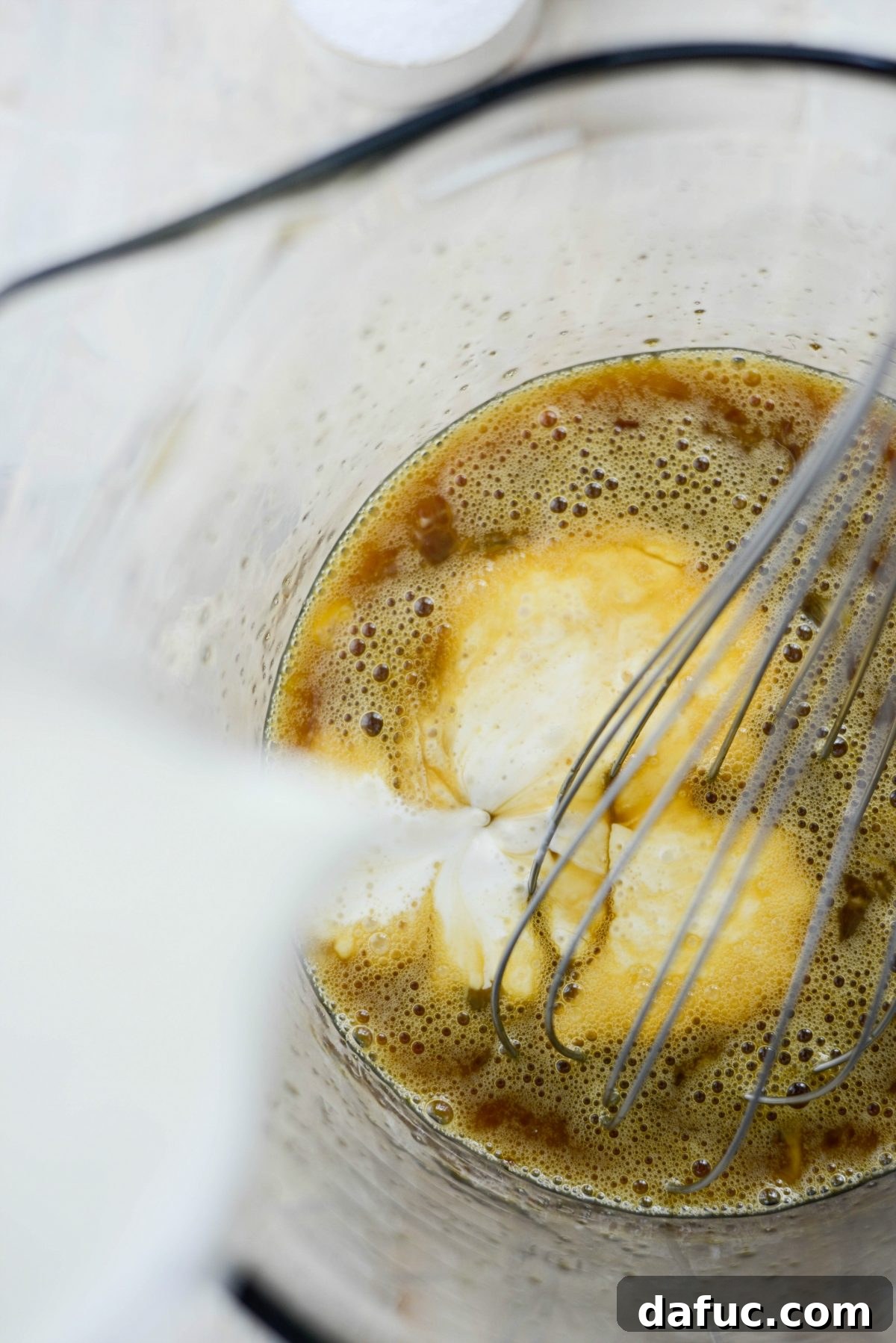 Adding half and half to the custard mixture