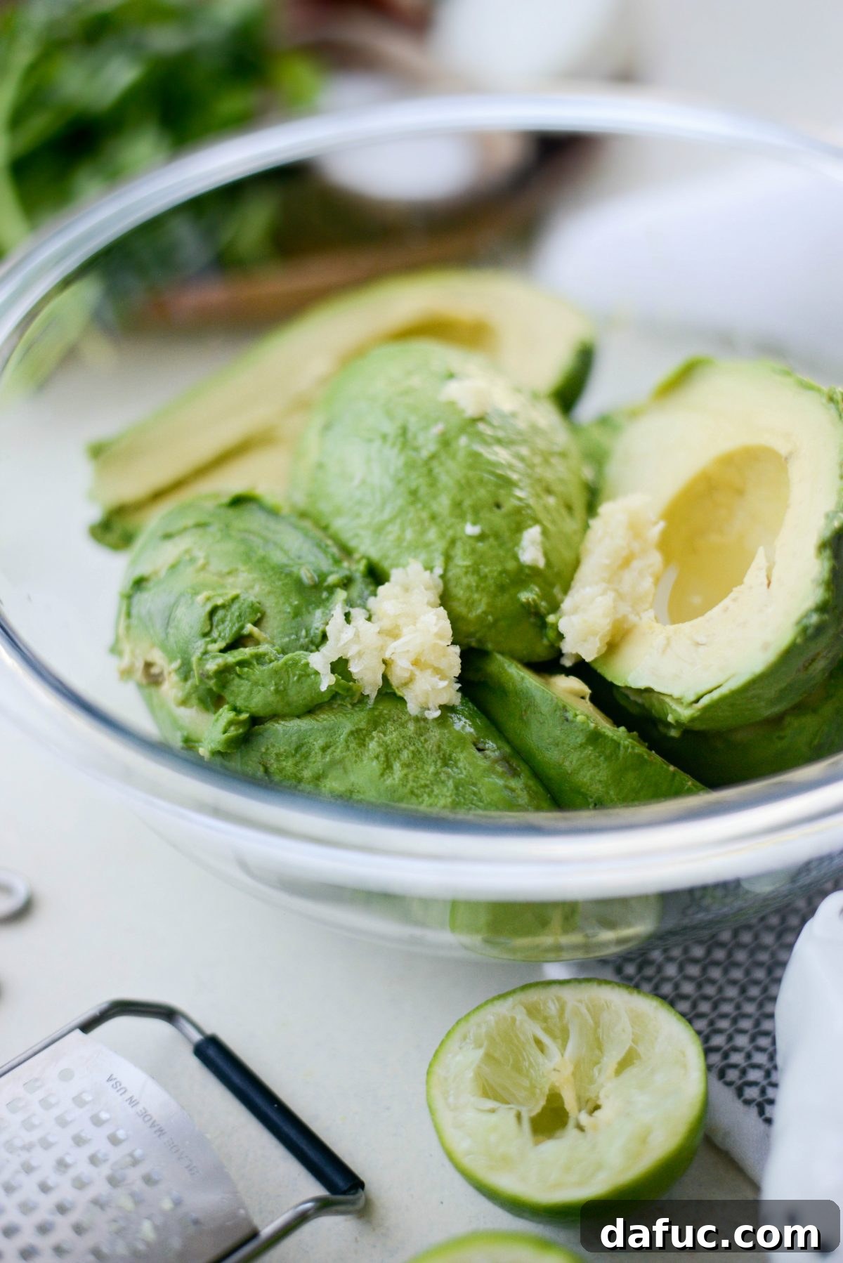 Grated garlic mixed with avocado and lime juice in a bowl