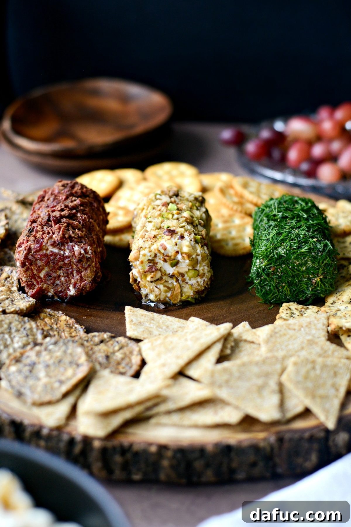 Christmas Goat Cheese Trio beautifully arranged on a rustic wooden platter