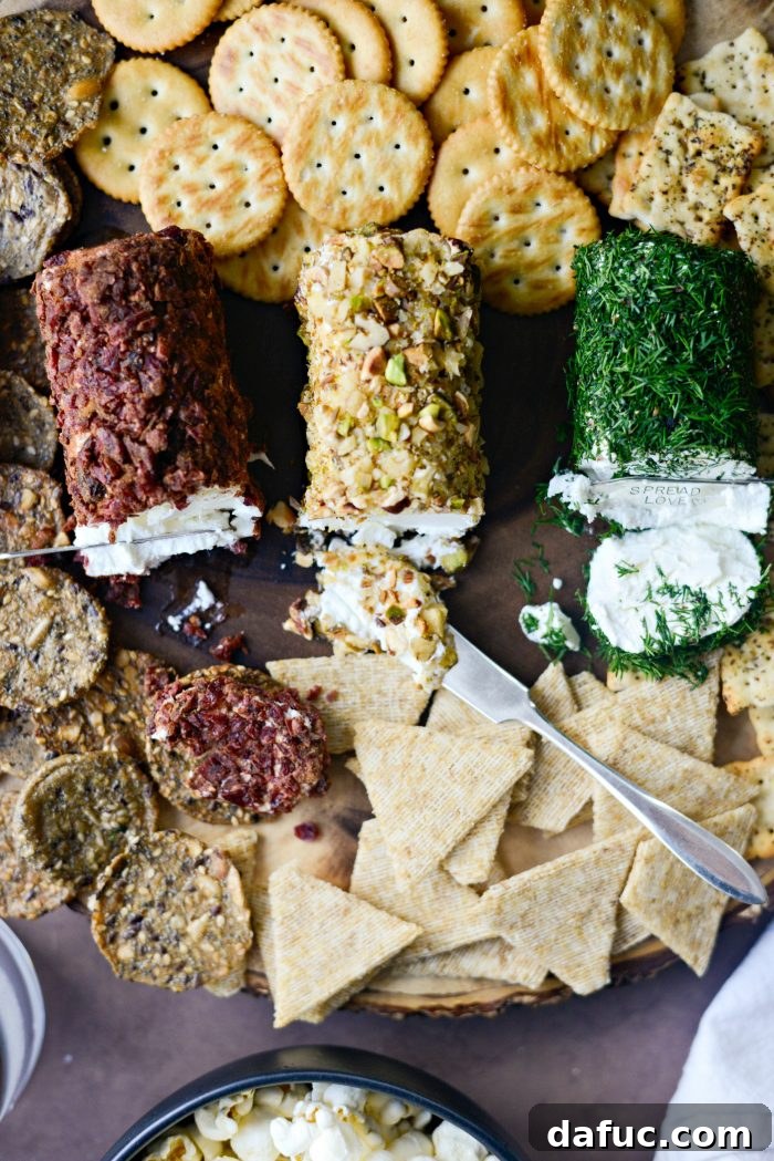 A cracker with a spread of the Christmas Goat Cheese Trio, showcasing a bite taken