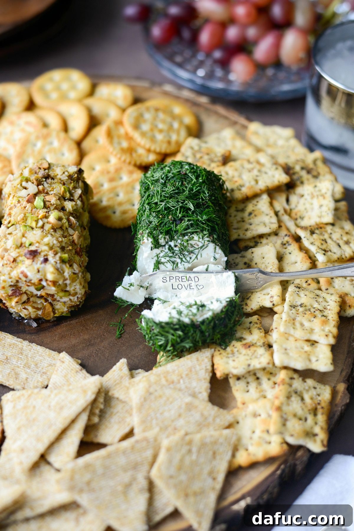 Close up view of the dill and black pepper coated goat cheese log on a platter