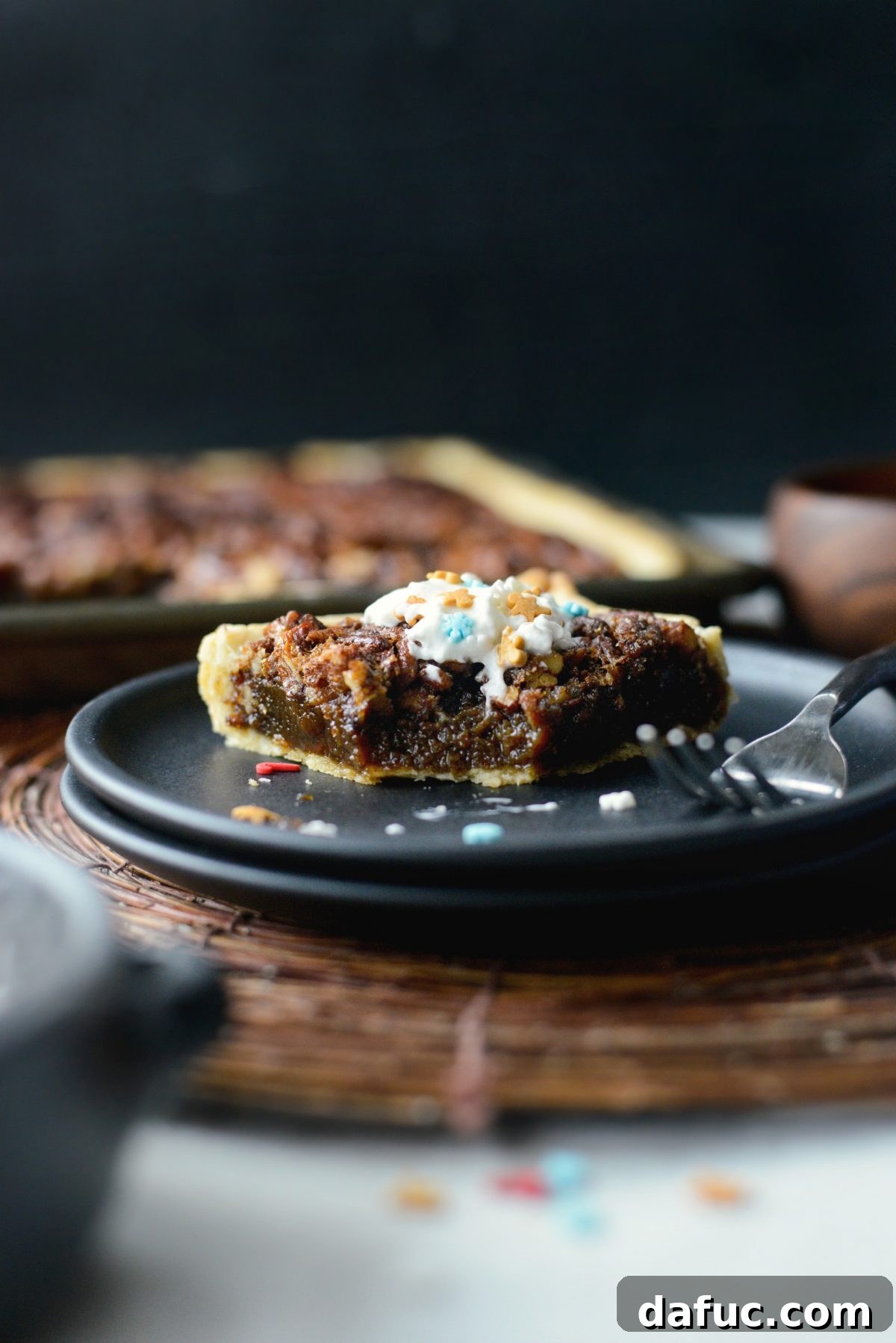 A slice of Gingerbread Pecan Slab Pie with a bite taken out