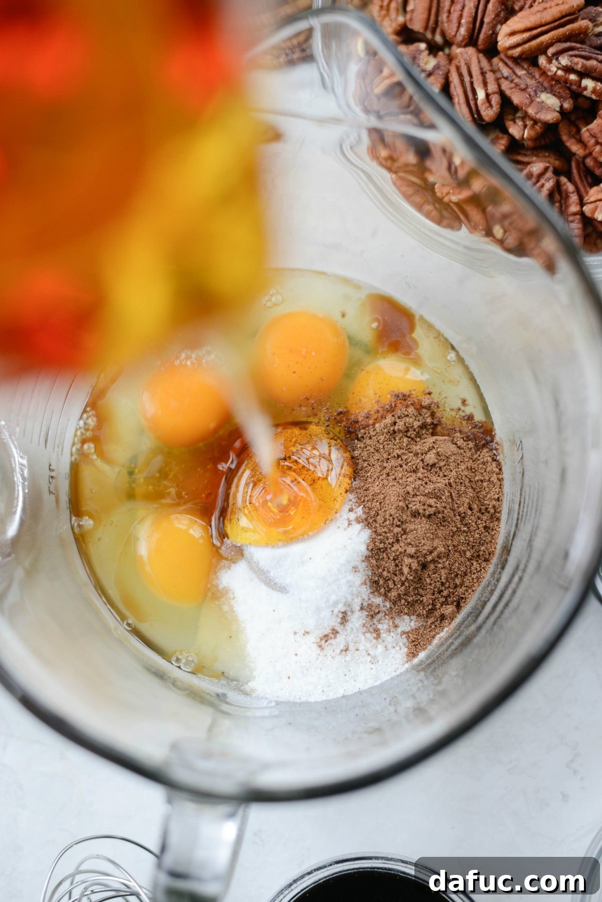 Adding golden syrup and molasses to the wet ingredients in a bowl