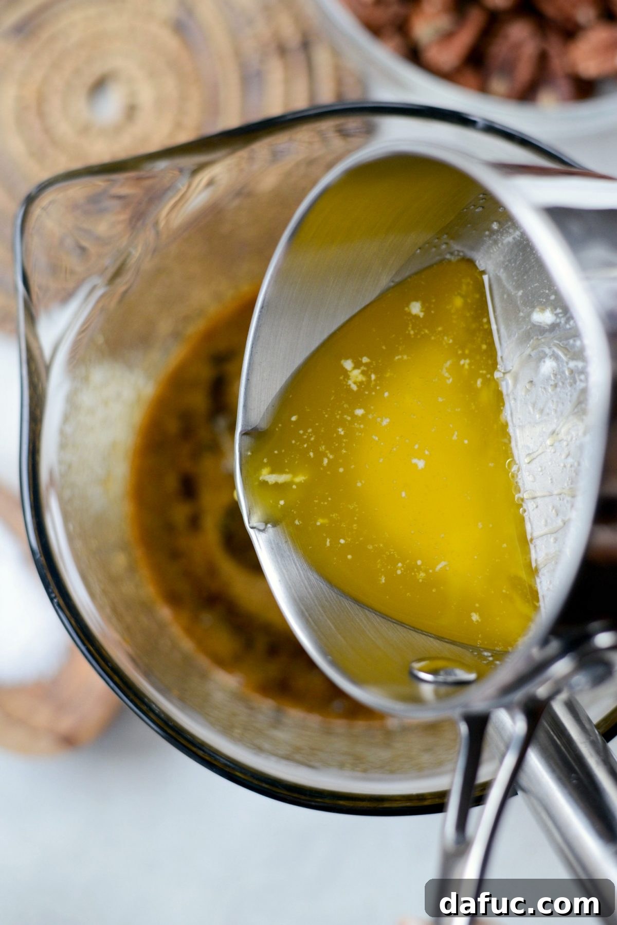 Pouring cooled melted butter into the pie filling mixture